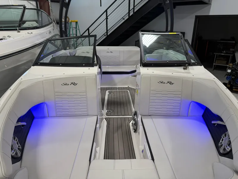 Slide: The Image of 2023 Sea Ray SPX 190 boat interior with blue LED lighting and sleek design. - 25