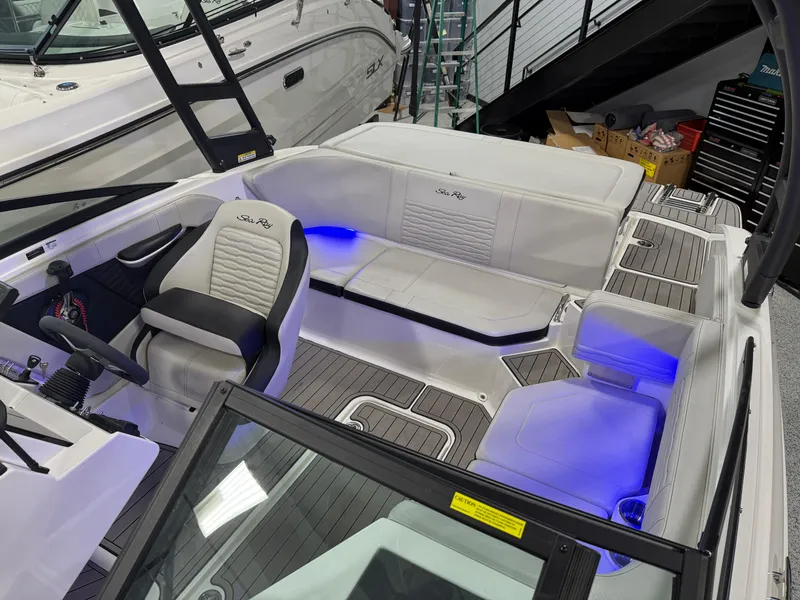 Slide: The Image of 2023 Sea Ray SPX 190 boat interior with blue LED lighting and modern seating. - 29