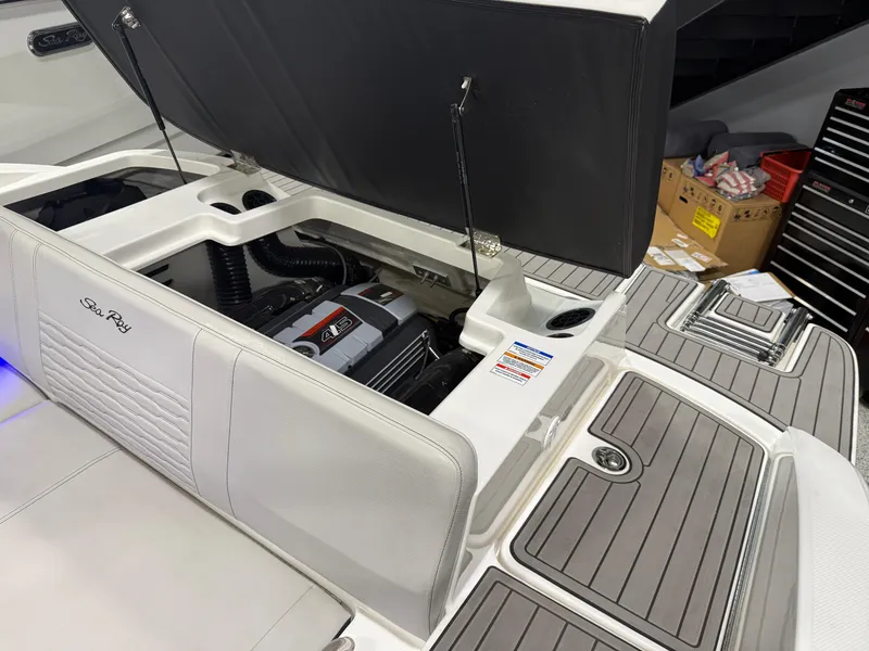 Slide: The Image of 2023 Sea Ray SPX 190 boat engine compartment with open hatch, showcasing interior details. - 35