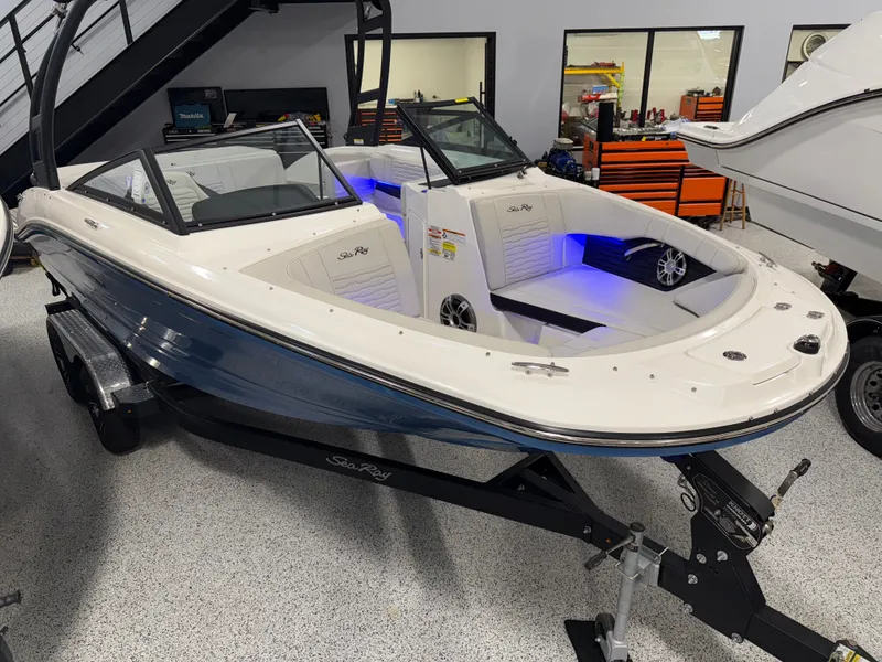 Slide: The Image of 2023 Sea Ray SPX 190 boat in showroom, featuring sleek design and modern interior lighting. - 4