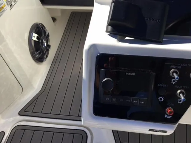 Slide: The Image of 2023 Sea Ray SPX 190 boat interior with Fusion audio system and sleek flooring. - 40