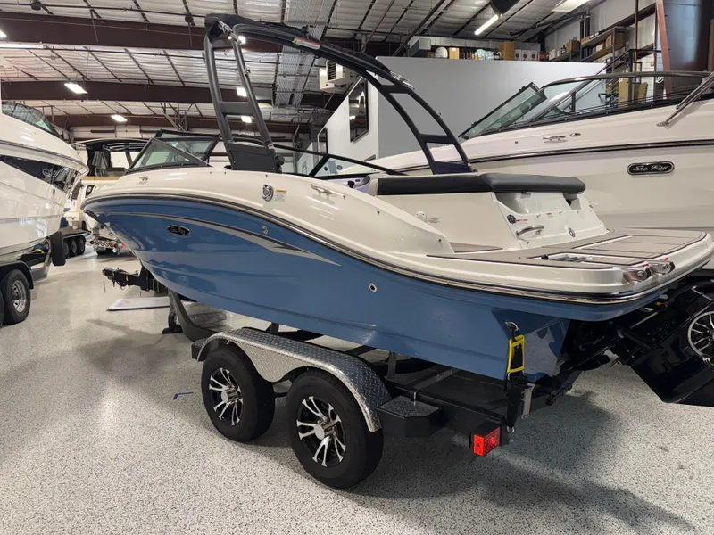 Slide: The Image of 2023 Sea Ray SPX 190 boat in showroom, blue hull, on trailer. - 6