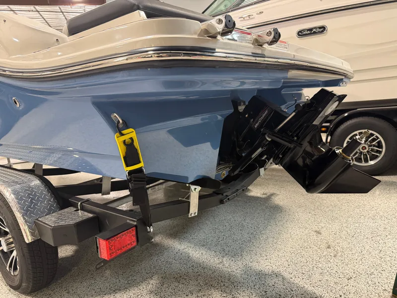 Slide: The Image of 2023 Sea Ray SPX 190 boat on trailer, showcasing blue hull and outboard motor. - 7