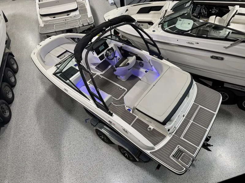 Slide: The Image of 2023 Sea Ray SPX 190 boat in showroom, featuring sleek design and modern interior. - 8