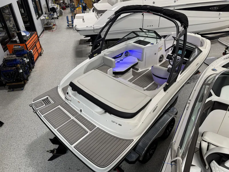 Slide: The Image of 2023 Sea Ray SPX 190 boat in showroom, featuring sleek design and modern interior. - 9
