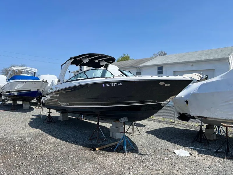 The Image of 2020 Monterey 275 Super Sport boat on stands in a storage yard. - 1