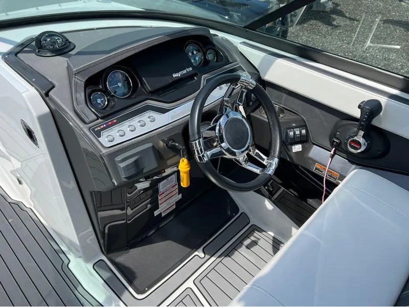 Slide: The Image of 2020 Monterey 275 Super Sport boat dashboard with steering wheel and controls. - 3