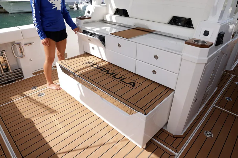 Slide: The Image of 2023 Formula 387 Center Console Fish boat interior with teak flooring and storage. - 14
