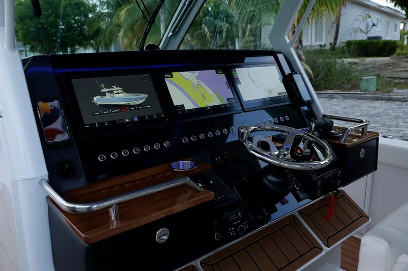 Slide: The Image of 2023 Formula 387 Center Console Fish dashboard with advanced navigation displays and controls. - 16