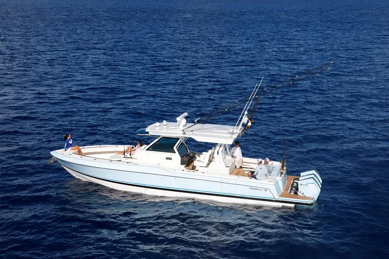 Slide: The Image of 2023 Formula 387 Center Console Fish boat cruising on open ocean waters. - 2