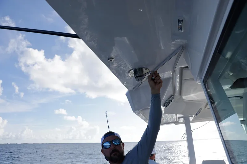 Slide: The Image of Man adjusting equipment on 2023 Formula 387 Center Console Fish boat at sea. - 21