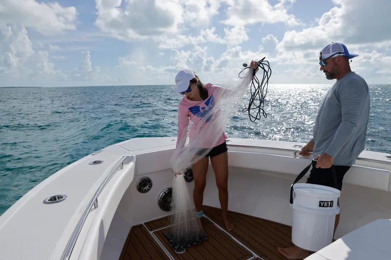 Slide: The Image of Two people fishing on a 2023 Formula 387 Center Console boat. - 22