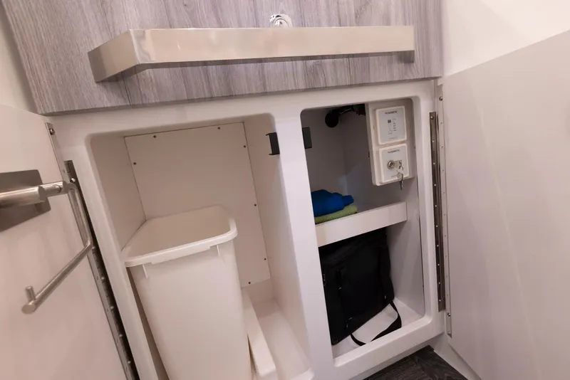 Slide: The Image of 2023 Formula 387 Center Console Fish interior storage compartments with sink. - 23