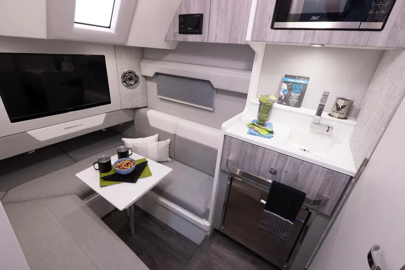 Slide: The Image of 2023 Formula 387 Center Console Fish interior with modern kitchenette and seating area. - 25