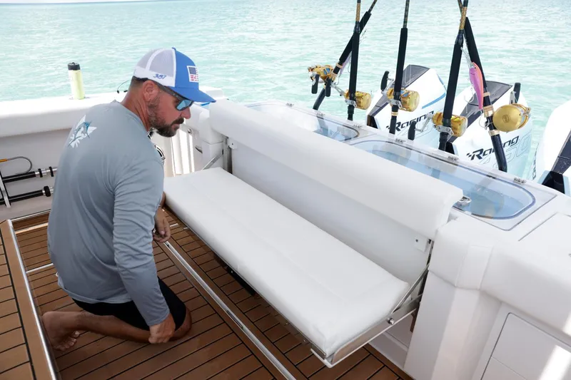 Slide: The Image of Man adjusting seat on 2023 Formula 387 Center Console Fish boat. - 6