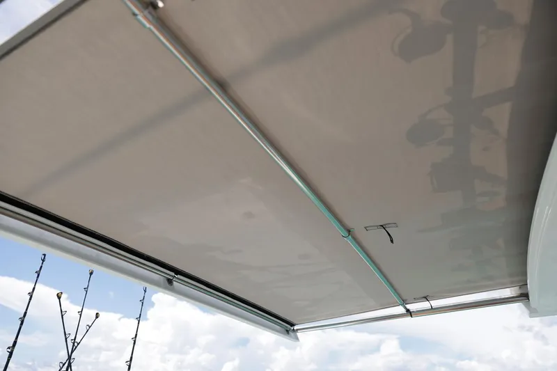 Slide: The Image of 2023 Formula 387 Center Console Fish boat canopy against a cloudy sky. - 7
