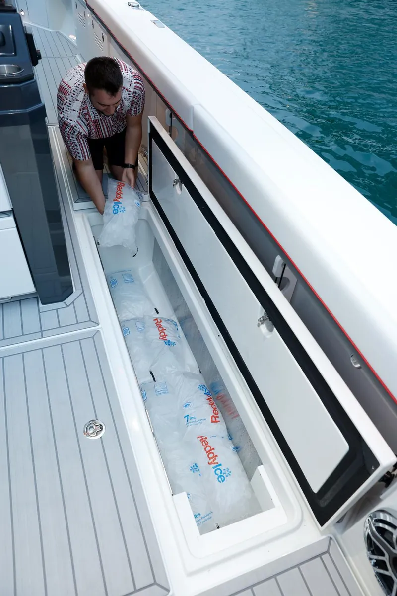 Slide: The Image of 2023 Formula 387 Center Console Sport boat with large storage compartment. - 11