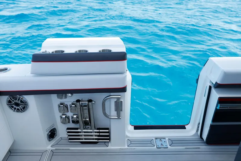 Slide: The Image of 2023 Formula 387 Center Console Sport boat with open side door on blue water. - 15