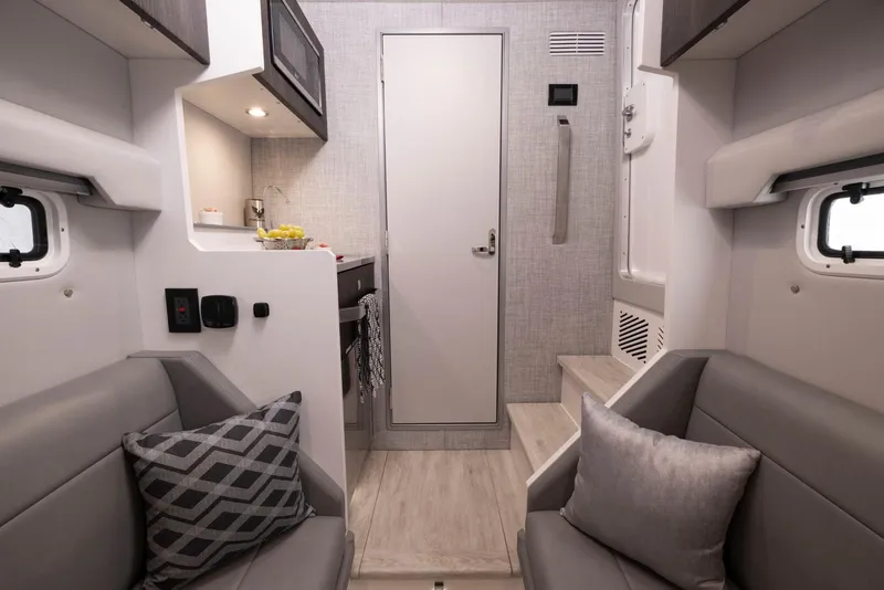 Slide: The Image of Interior of 2023 Formula 387 Center Console Sport boat with modern seating and kitchenette. - 18