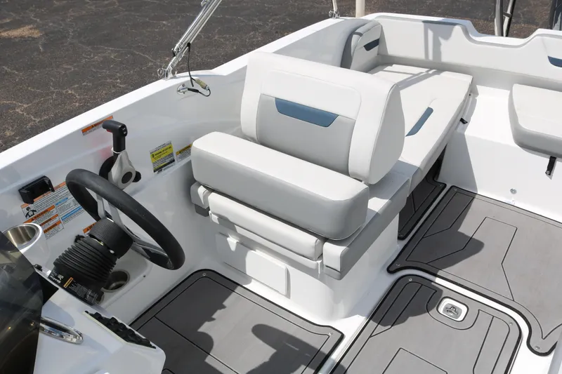 Slide: The Image of 2023 Hurricane SUN DECK 205 OB boat interior with steering wheel and seating. - 24