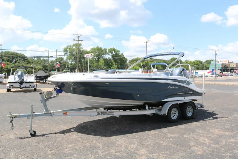 Slide: The Image of 2023 Hurricane SUN DECK 205 OB boat on a trailer in a parking lot. - 3