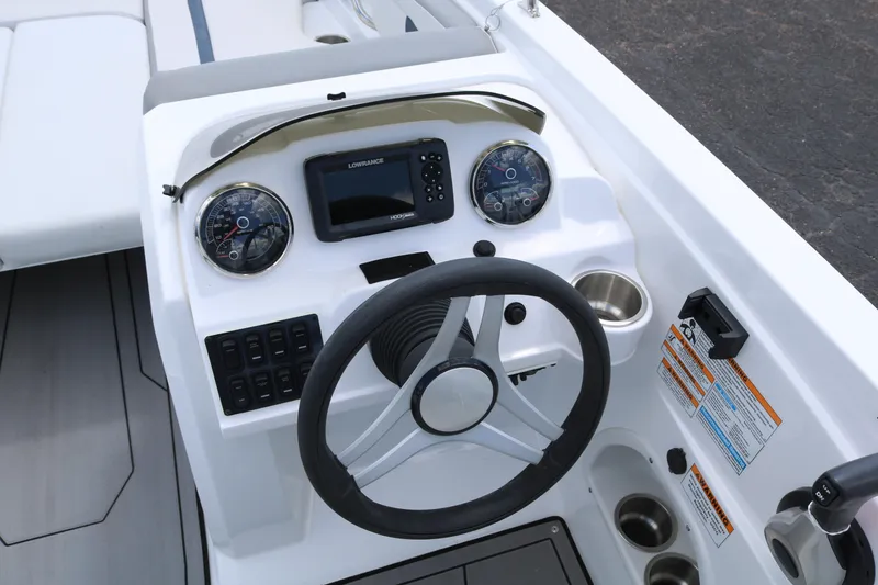 Slide: The Image of 2023 Hurricane SUN DECK 205 OB boat dashboard with steering wheel and control panel. - 36
