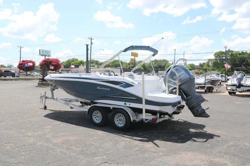 Slide: The Image of 2023 Hurricane SUN DECK 205 OB boat on a trailer in a parking lot. - 5