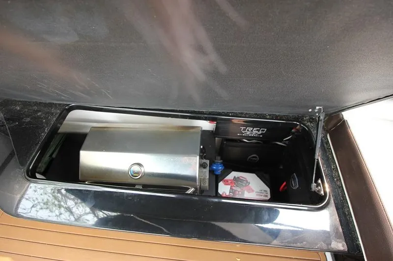Slide: The Image of A 2016 Regal 2800 Bowrider featuring a built-in grill in the storage compartment. - 24
