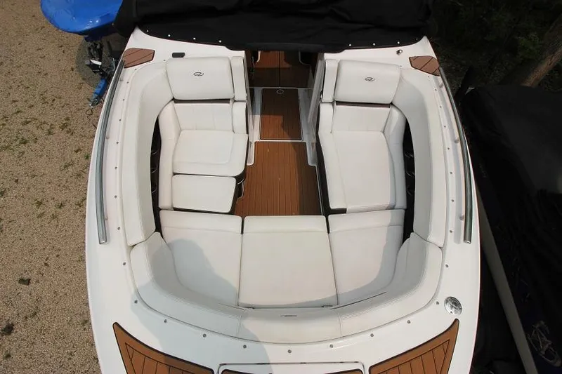 Slide: The Image of The 2016 Regal 2800 Bowrider features a spacious, cushioned seating arrangement with wood floor accents. - 23