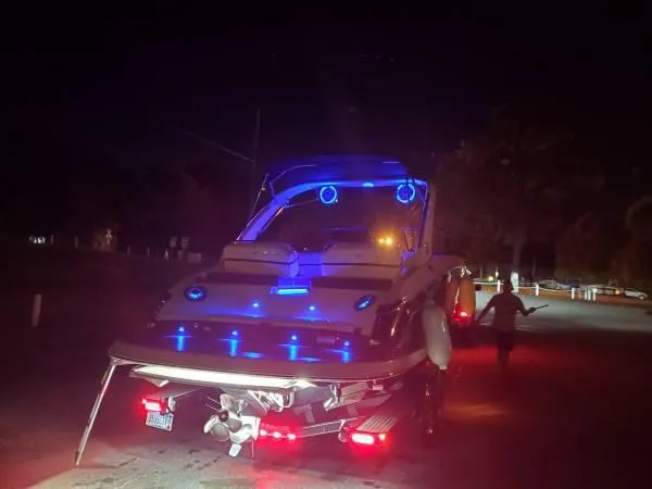 Slide: The Image of A 2016 Regal 2800 Bowrider with blue lighting, on a trailer at night. - 30