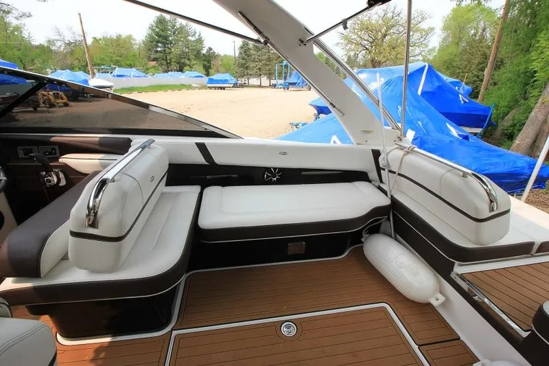 Slide: The Image of The image shows the cockpit of a 2016 Regal 2800 Bowrider with white upholstery and wood flooring. - 9