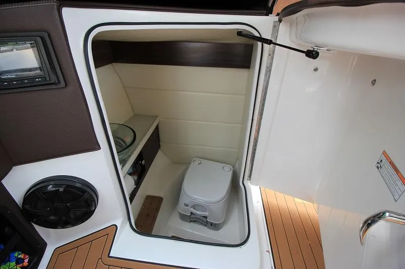 Slide: The Image of The image shows a toilet inside a 2016 Regal 2800 Bowrider boat. - 18
