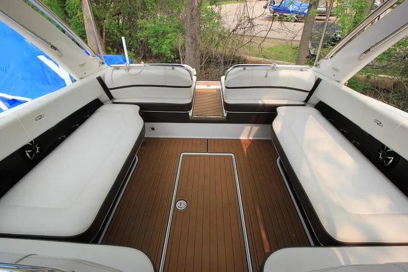 Slide: The Image of Interior of the 2016 Regal 2800 Bowrider with sleek white seating and wood flooring. - 10