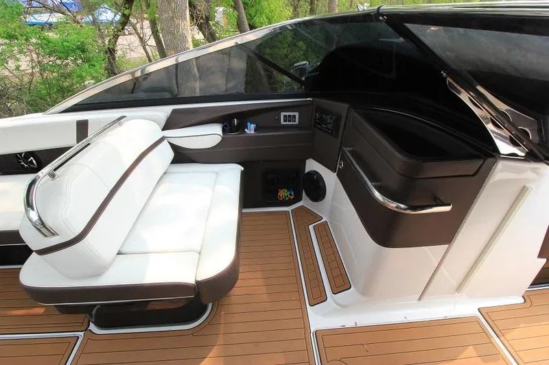 Slide: The Image of The image shows the cockpit of a 2016 Regal 2800 Bowrider with sleek seating and wood flooring. - 13