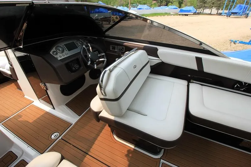 Slide: The Image of The image shows the cockpit of a 2016 Regal 2800 Bowrider with sleek seating and wood accents. - 15