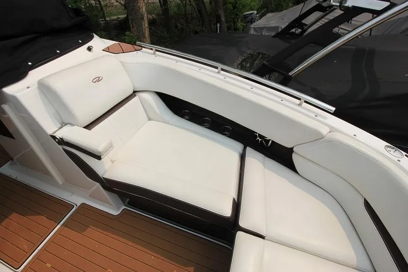 Slide: The Image of The image shows the cockpit of a 2016 Regal 2800 Bowrider with white upholstery and wood flooring. - 21