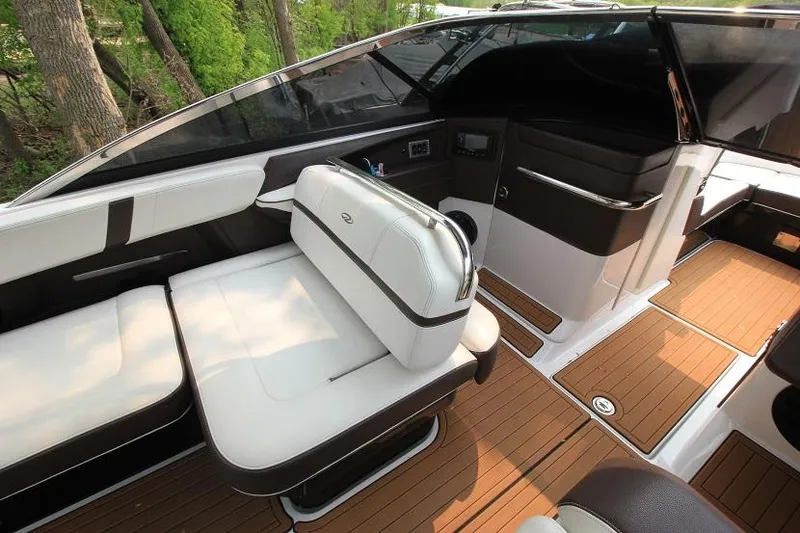 Slide: The Image of The image shows the cockpit of a 2016 Regal 2800 Bowrider with sleek seating and wood flooring. - 12