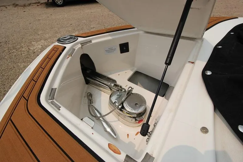 Slide: The Image of Anchor locker of a 2016 Regal 2800 Bowrider with anchor and rope. - 28