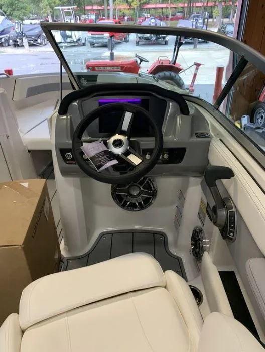 Slide: The Image of 2023 Chaparral 21 Surf boat interior with steering wheel and dashboard. - 3