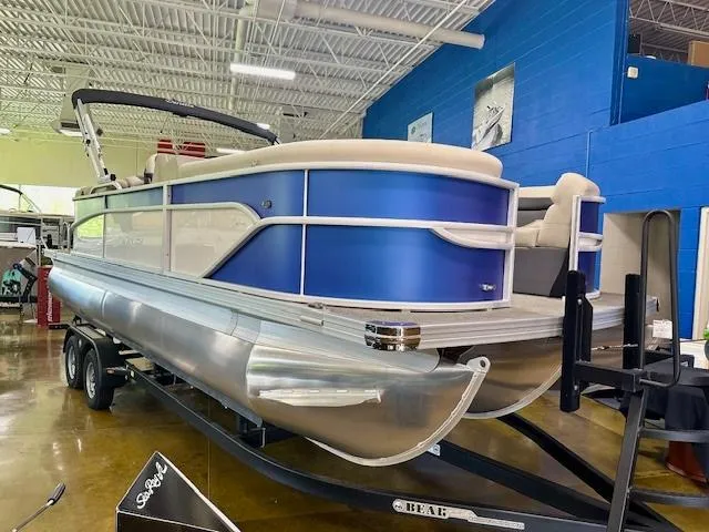 Slide: The Image of 2023 Barletta Cabrio 22QC pontoon boat on display in a showroom. - 3