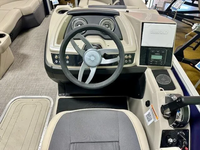 Slide: The Image of 2023 Barletta Cabrio 22QC boat dashboard with steering wheel and control panel. - 6