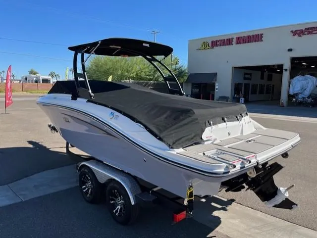 Slide: The Image of 2023 Sea Ray SPX 210 boat on trailer outside marine shop. - 22