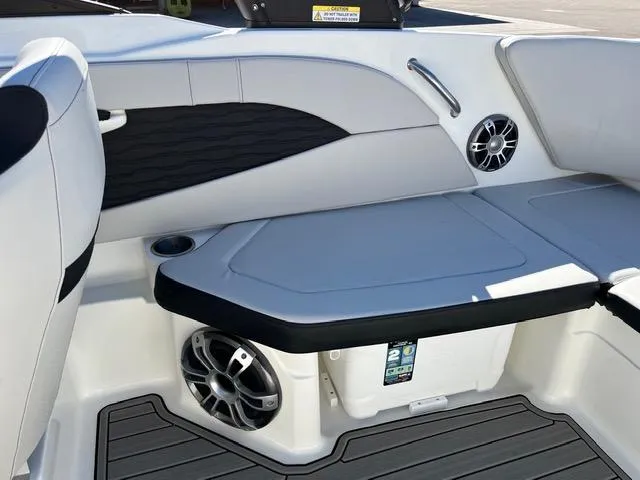 Slide: The Image of 2023 Sea Ray SPX 210 boat interior with cushioned seating and built-in speakers. - 28