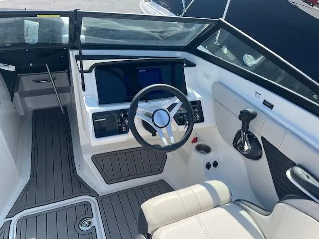 Slide: The Image of 2023 Sea Ray SPX 210 boat cockpit with steering wheel and control panel. - 44