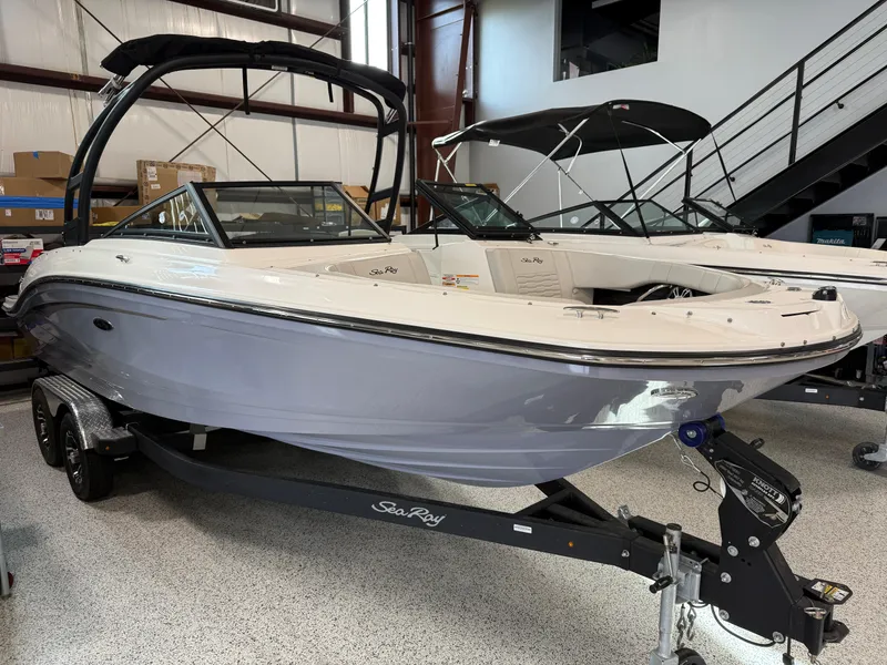 Slide: The Image of 2023 Sea Ray SPX 210 boat on trailer in showroom setting. - 51
