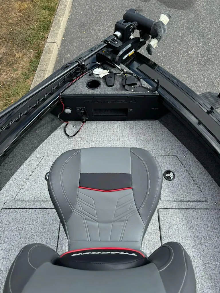 Slide: The Image of 2023 Tracker Targa V-19 WT boat interior with gray seating and control panel. - 12