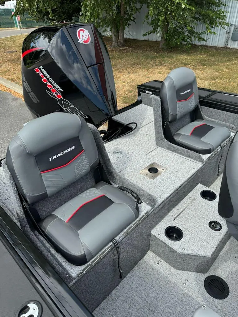 Slide: The Image of 2023 Tracker Targa V-19 WT boat interior with dual seats and Mercury engine. - 4
