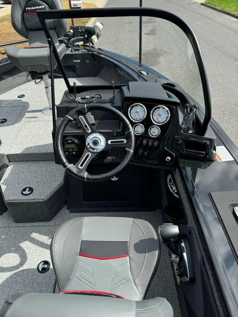 Slide: The Image of 2023 Tracker Targa V-19 WT boat interior with steering wheel and dashboard controls. - 8