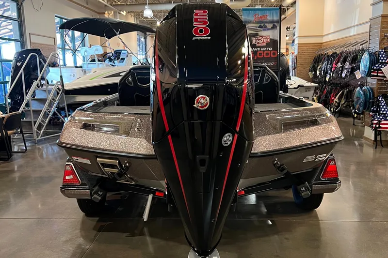 Slide: The Image of 2023 Ranger Z521R boat with a 250 HP engine on display indoors. - 3