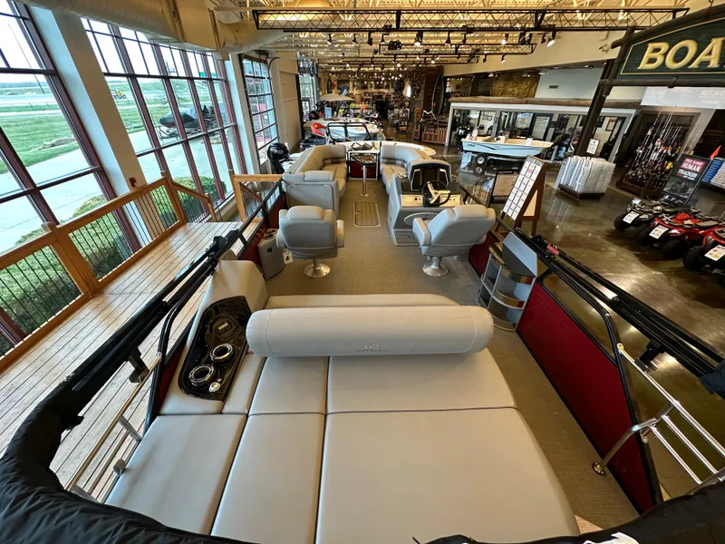 Slide: The Image of 2023 Regency 250 LE3 Sport pontoon boat interior in showroom. - 2